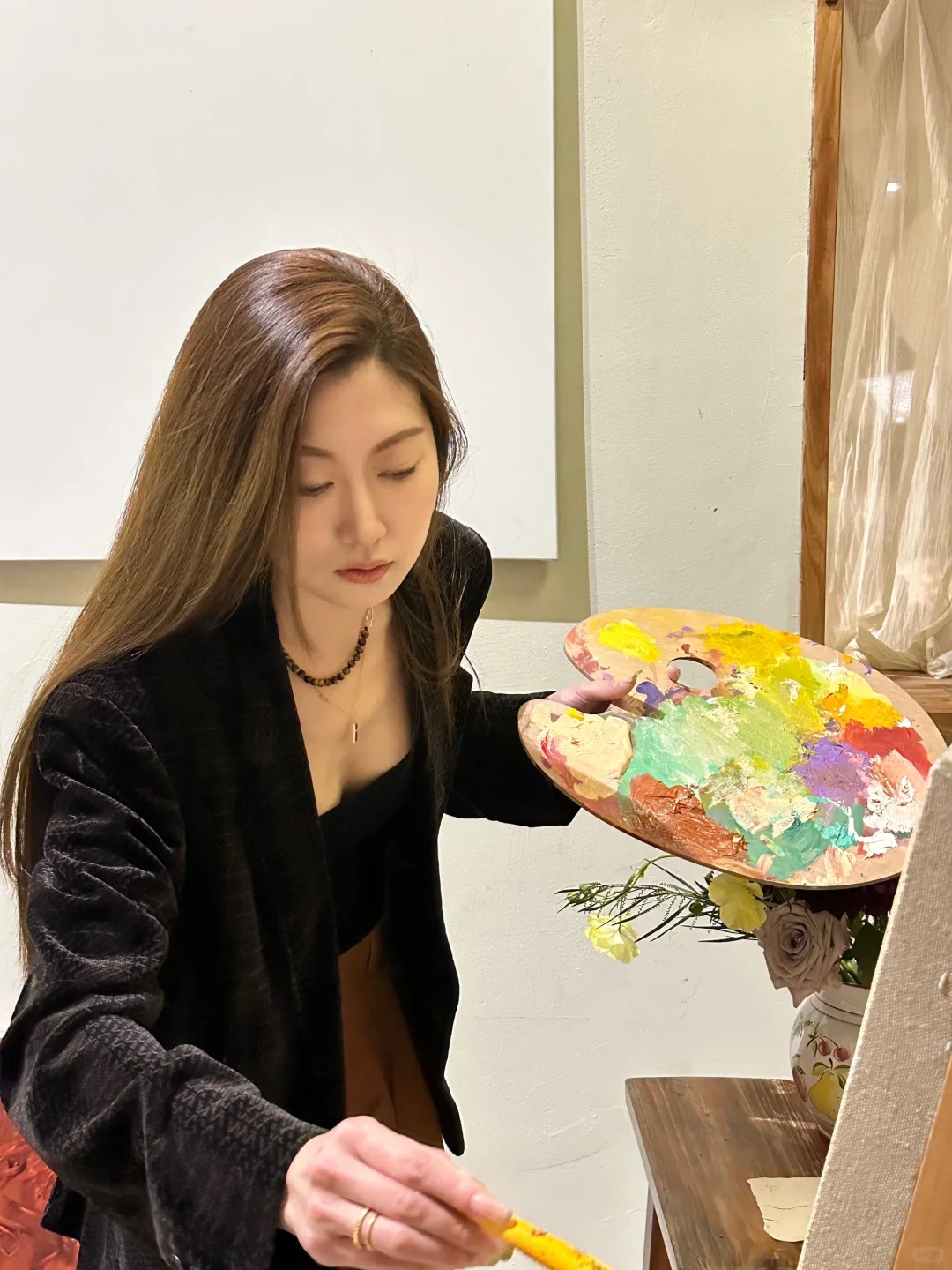 Gabby smiling with her Tibetan Terrier, Lily, inside their studio.