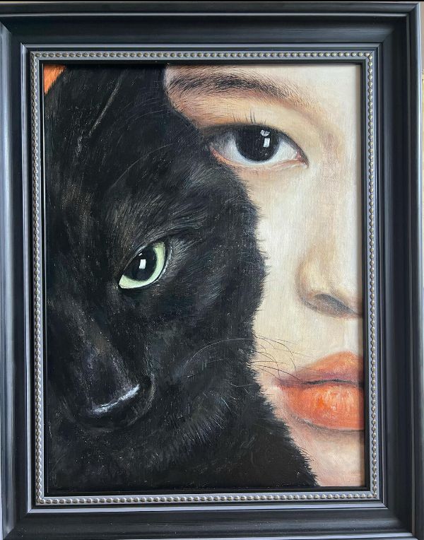 Family gathered around a memorial oil portrait of their black and white cat, Groucho